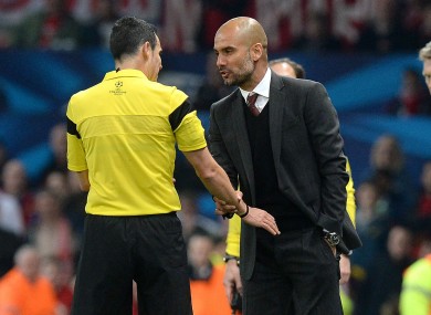 Bayern Munich's Pep Guardiola argues with referee Carlos Velasco Carballo after he gave a red card to Bastian Schweinsteiger.