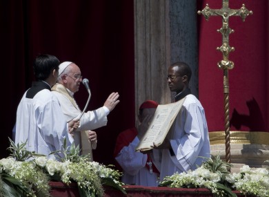 Pope Francis delivers his blessing at the end of the Urbi et Orbi (Latin for to the city and to the world) blessing from the balcony of St. Peter's Basilica.