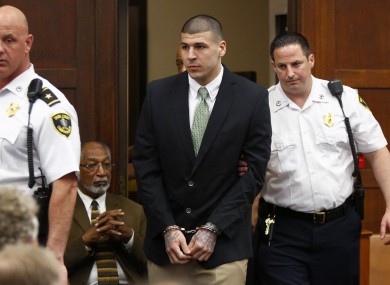 Hernandez is led into the courtroom yesterday.