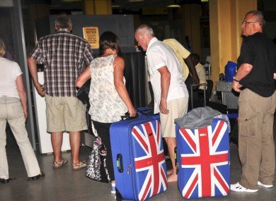 In this photo taken late Thursday, British tourists queue to prepare to leave the international airport in Mombasa.
