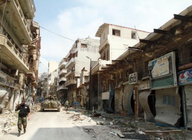 Pro-government troops patrol the old city of Homs.