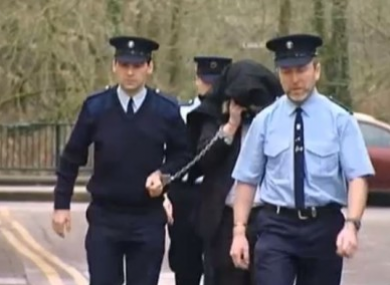 McGrath being led away from court during the murder case of Sylvia Roche Kelly.