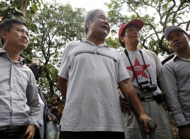 A small group of Vietnamese anti-China protesters stand near the Chinese Embassy in Hanoi, Vietnam today, before being ordered to leave the area by police