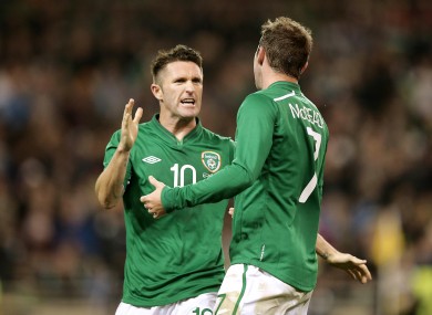 Keane celebrates with Aiden McGeady during his most recent international appearance, against Latvia.