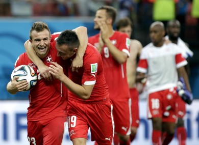Shaqiri carries off the match ball while embracing Drmić.