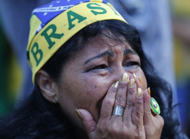 A fan of Brazil reacts as she watches as the Netherlands score a second goal against Brazil.