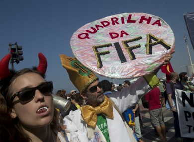 'FIFA gang' reads one protester's sign.