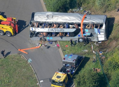 The wreckage of the bus and rescue vehicles off the motorway this morning