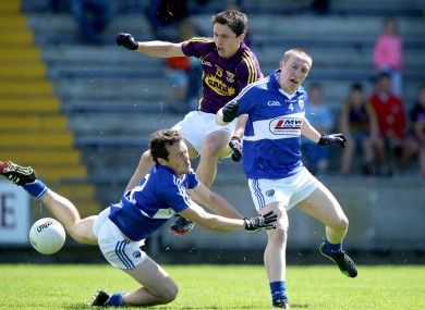 Wexford's Ciaran Lyng with Padraig McMahon and Peter O'Leary of Laois.