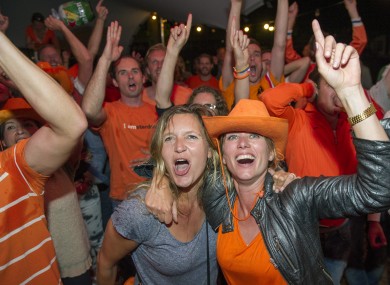 People celebrate as they watch the Dutch team win after penalties in the World Cup quarter-finals.