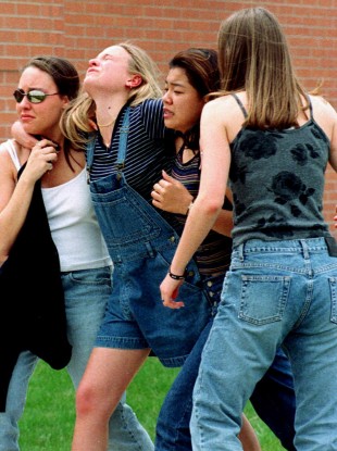A girl is carried away from Columbine on the day of the massacre.