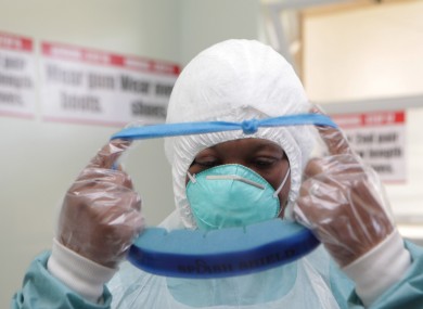 A woman wears protective clothing during a tour of one of the Ebola Centers in Harare, Zimbabwe.