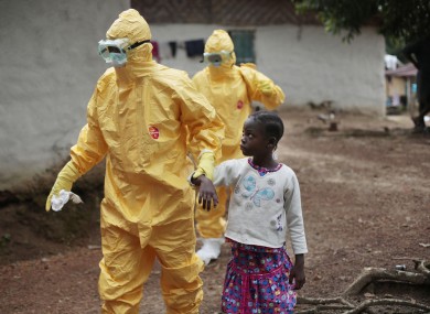 Nowa Paye, 9, is taken to an ambulance after showing signs of the Ebola infection in the village of Freeman Reserve.