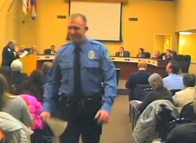 In this February, 2014 file image from video released by the City of Ferguson, Mo., officer Darren Wilson attends a city council meeting in Ferguson.