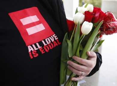 FILE: Kim Gillen holds flowers for friends applying for a marriage license at the Oakland County Clerks office