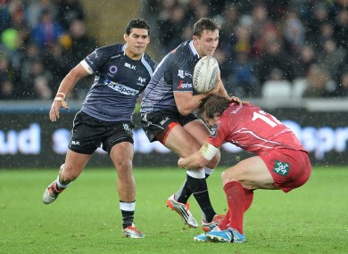 Ashley Beck carries the ball at a wet Liberty Stadium.
