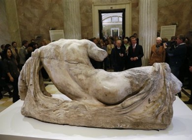 Hermitage director Mikhail Piotrovsky, center left, and British Museum director Neil MacGregor attend the opening of the exhibition on Greek art with the marble sculpture of the river god Ilissos, in front, in the Hermitage in St. Petersburg, Russia.