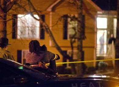 A couple embraces as they wait after requesting to speak with police officers upon arriving at the shooting scene where authorities say five people are dead, including the gunman, in Douglasville.