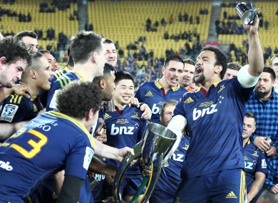 The Highlanders players celebrate with their team song at full-time.