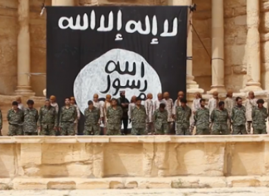 In a clip from the video, teen soldiers line up behind Syrian military members, shortly before they execute them.