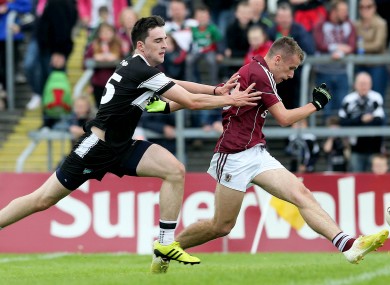 Ryan Forde and Michael Gordon battle it out for possession.