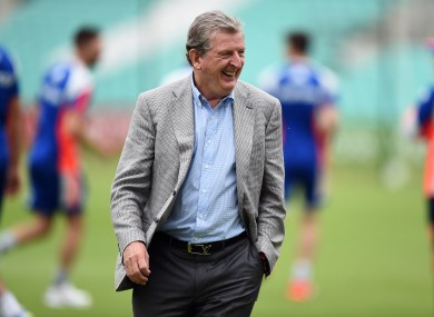 Hodgson makes his way off the pitch after chatting with the cricket team.