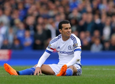 Chelsea's Pedro sits dejected on the turf during his team's loss to Everton on Saturday.