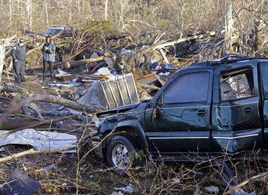 A vehicle sits among debris in an area near Linden, Tennessee.