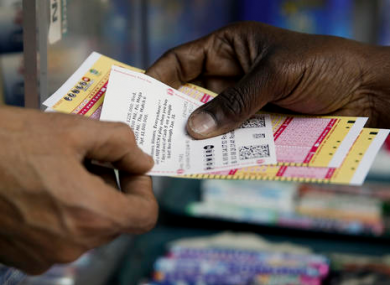 A person purchase Powerball lottery tickets from a newsstand in Philadelphia.