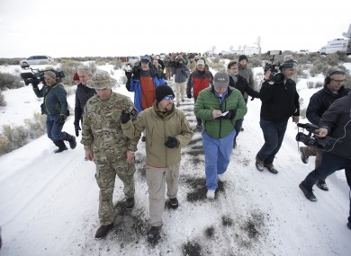 Members of the group occupying the Malheur National Wildlife Refuge headquarters, left, conduct a tour with the media.