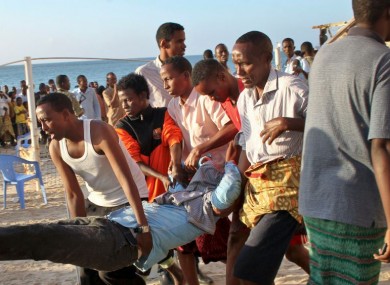 Relatives carry away a dead body from the beach following an overnight attack on a beachfront restaurant in Mogadishu, Somalia.