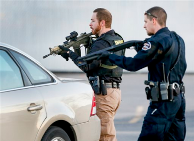 Police look for a possible second shooter in the parking lot of Excel Industries.