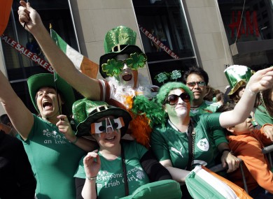 Deirdre Kelly, Linda Forth, Darren McCarthy and Eimear Ni Bhriain, of Dublin cheer on the marchers during the 2012 parade in New York.