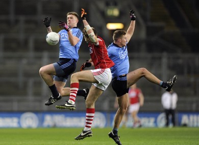 Dublin's Shane Carthy and Ciaran Kilkenny battling for the ball with Cork's Ian Maguire.