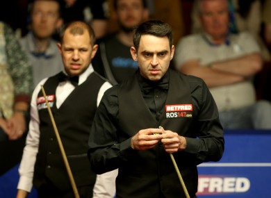 Barry Hawkins and Ronnie O'Sullivan (right) during day nine of the Betfred Snooker World Championships at the Crucible..