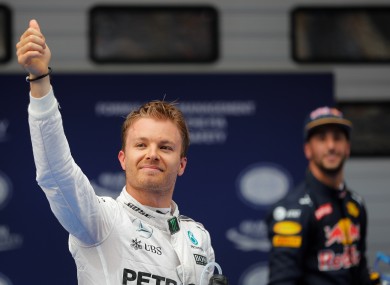 Mercedes driver Nico Rosberg of Germany, left, gestures near Red Bull driver Daniel Ricciardo of Australia after taking pole in the qualifying session for the Chinese Formula One Grand Prix at Shanghai International Circuit.