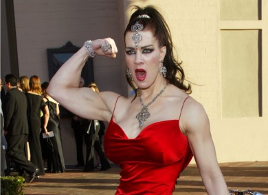 In this Nov. 16, 2003, file photo, Joanie Laurer, former pro wrestler known as Chyna, flexes her bicep as she arrives at the 31st annual American Music Awards.