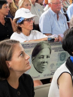 A campaigner with a mock-up of a Tubman $20 bill.