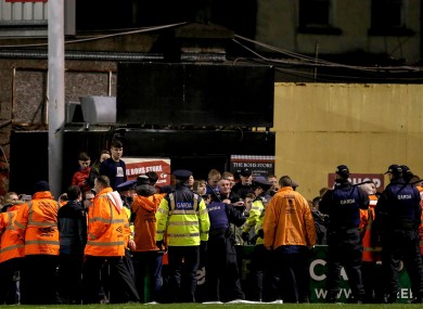 Members of the Gardai hold back Bohs' fans.
