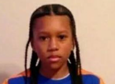 The 12-year-old was sitting in his father's car when he was caught in crossfire and shot in the head.