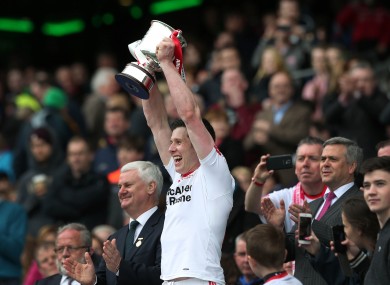 Cavanagh lifts the cup in the Hogan Stand.