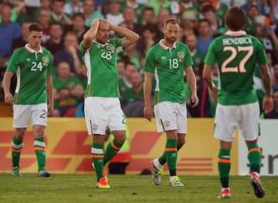 The Irish players look dejected after conceding a goal.