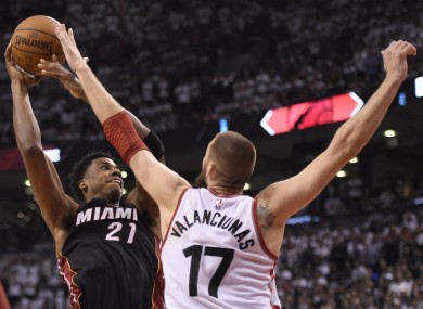 Toronto Raptors' Jonas Valanciunas stops Miami Heat's Hassan Whiteside during overtime.
