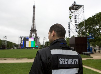 A security guard looks at the Euro 2016 fan zone, under construction on the Champs de Mars in Paris.