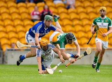 Offaly's Kevin Connolly is battles for possession with Laois goalkeeper Enda Rowland.