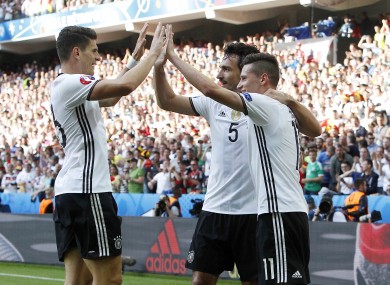 Julian Draxler, right, celebrates with his teammates Mats Hummels, center, and Mario Gomez after Germany beat Slovakia.