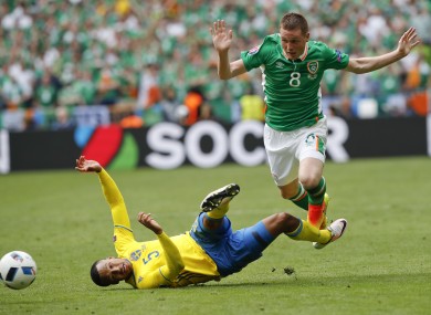 James Mccarthy, right, jumps past Sweden's Martin Olsson.