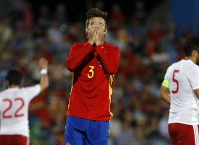 Spain's Gerard Pique covers his face after missing a chance during this evening's defeat to Georgia.