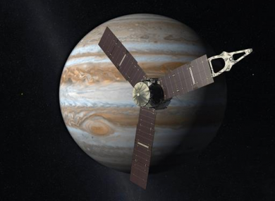 This artist's rendering provided by NASA and JPL-Caltech shows the Juno spacecraft above the planet Jupiter.