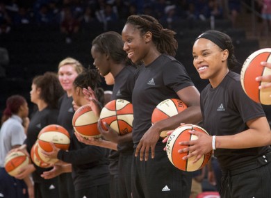 In this Wednesday, 13 July, 2016 file photo, members of the New York Liberty basketball team await the start of a game against the Atlanta Dream in New York. The WNBA is withdrawing its fines for teams and players that showed support of citizens and police involved in recent shootings by wearing black warmup shirts before and during games. WNBA President Lisa Borders said in a statement Saturday, 23 July, the league was rescinding penalties given to the Indiana Fever, New York Liberty, Phoenix Mercury and their players for wearing the shirts.